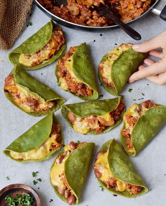 Green shelled filled tacos arranged in a circle form formation