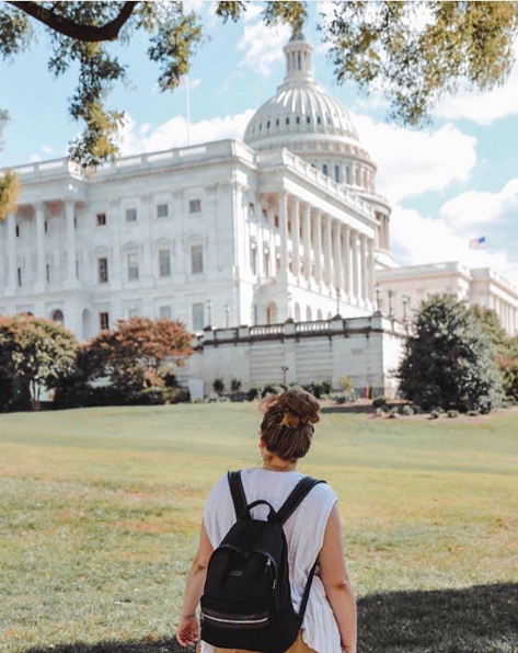Woman with her back facing the camera, looking the White House in Washington